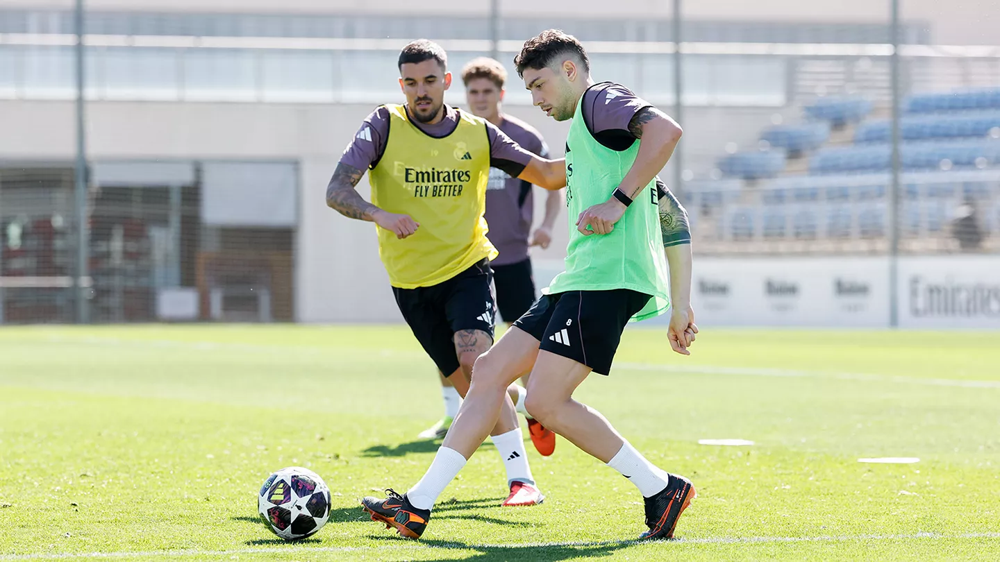 INICIO Fede Valverde controla el balón durante un entrenamiento del Real Madrid. Dani Ceballos aparece al fondo en una acción de presión sobre el campo de juego de la ciudad deportiva.